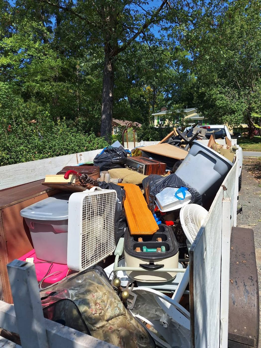 R. S. Thompson trailer fully loaded with hauled junk, furniture and bins